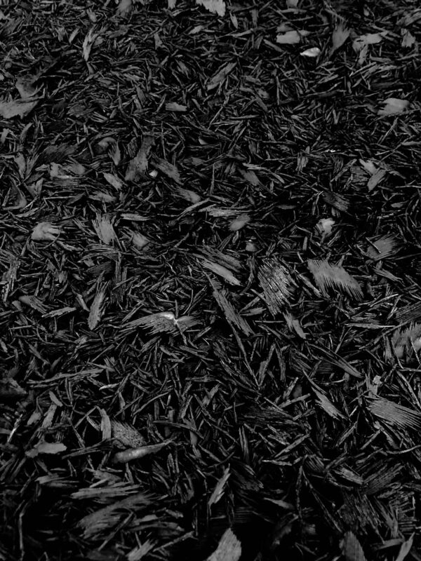 Triple ground black mulch made from dyed hardwood, ideal for landscaping in Alpharetta and Cumming, GA