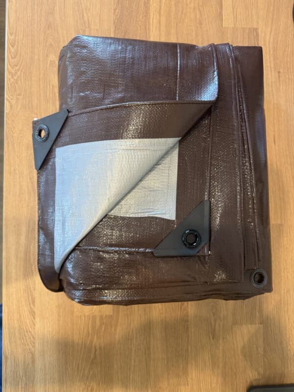 Folded Brown Tarp with Reinforced Corners and Grommets